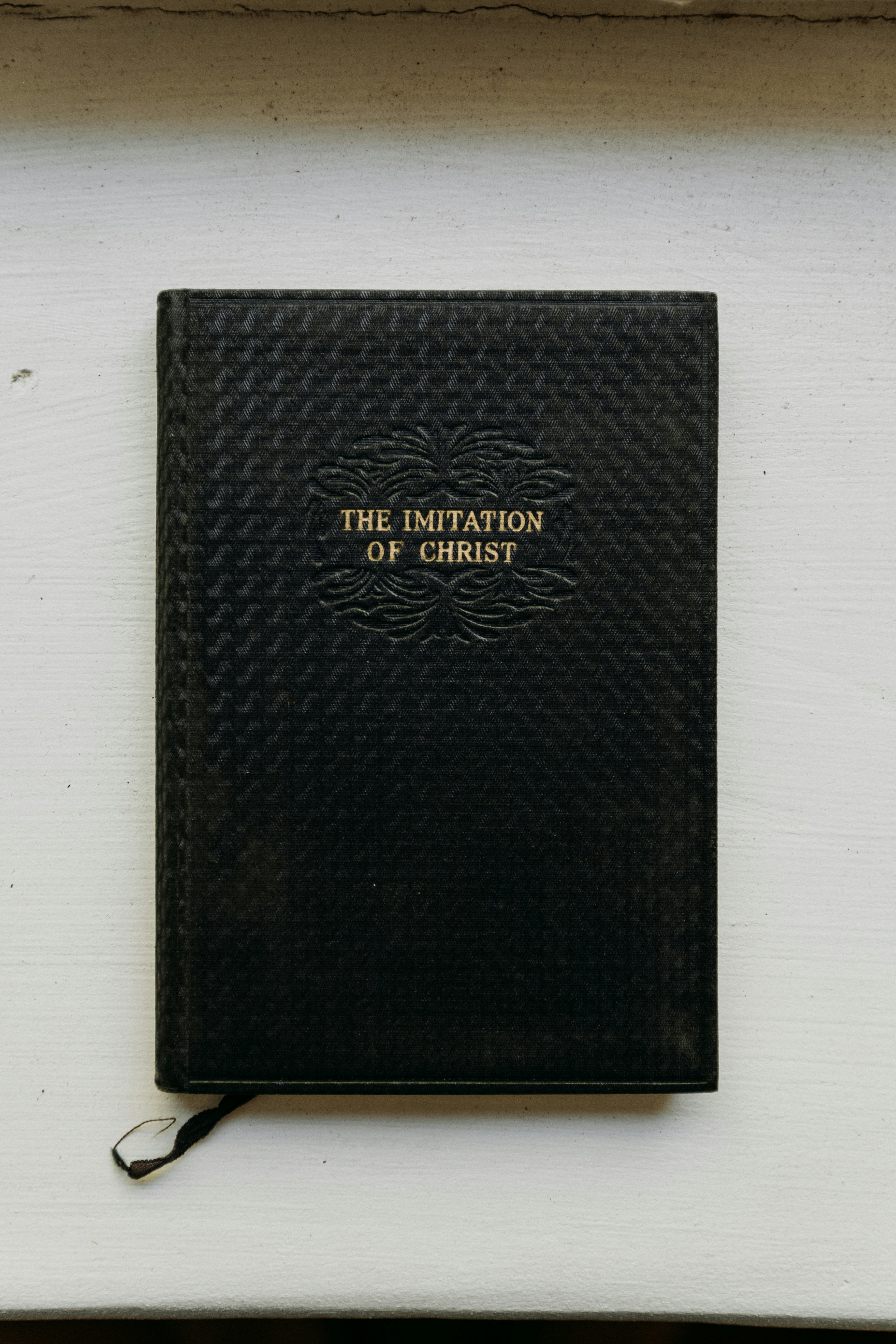 FAQ: Your Burning Dream Questions Answered 🔥 by Dreams About a black book sitting on top of a white wall